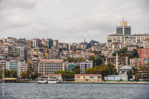  Tourist ship sails on the Golden Horn, Istanbul, Turkey. Scenic sunny panorama of Istanbul city in summer. Beautiful waterfront of Istanbul at sunset. Concept of traveling and vacation in Istanbul. © dianagrytsku