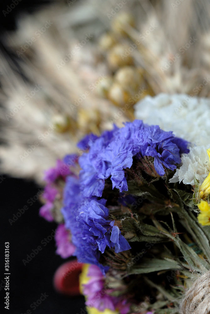 Elements of bouquet of dried flowers and spikelets closeup. Shallow depth of field