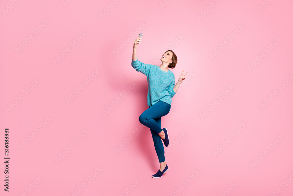 Full length body size view of her she nice attractive lovely cheerful cheery brown-haired girl having fun making taking selfie showing v-sign isolated over pink pastel color background