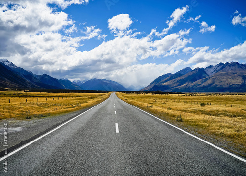Concept of success way. Straight road to the north. Road with the mountain.