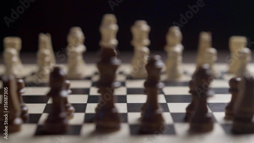Wallpaper Mural change of focus with the movement of the camera white chess against the background of black chess on a mirrored chessboard on a black background shallow depth of field Torontodigital.ca