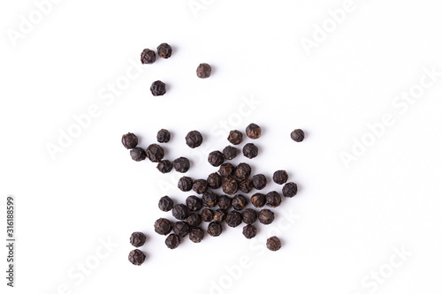 Black pepper viewed from above on white background. Flat lay