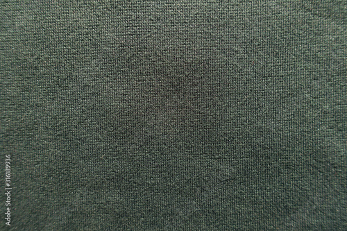 Surface of dark green jersey fabric from above