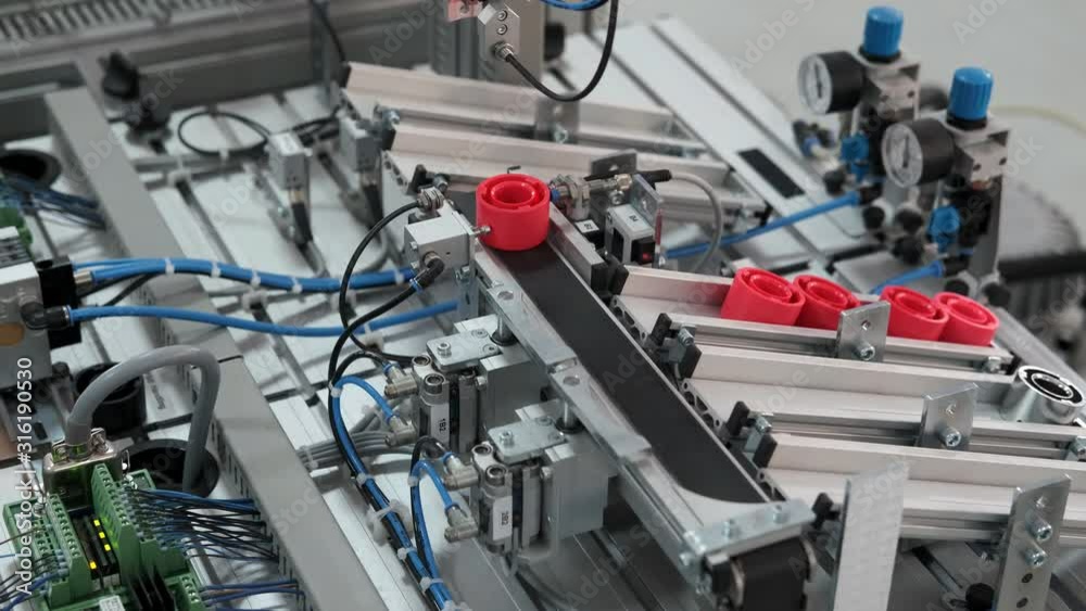 Close-up of product which automatically classified according to color in storage station. Handling and Sorting Application. Industry 4.0 concept; artificial intelligence in autonomous production. Close-up of product which automatically classified according to color in storage station. Handling and Sorting Application. Industry 4.0 concept; artificial intelligence in autonomous production.