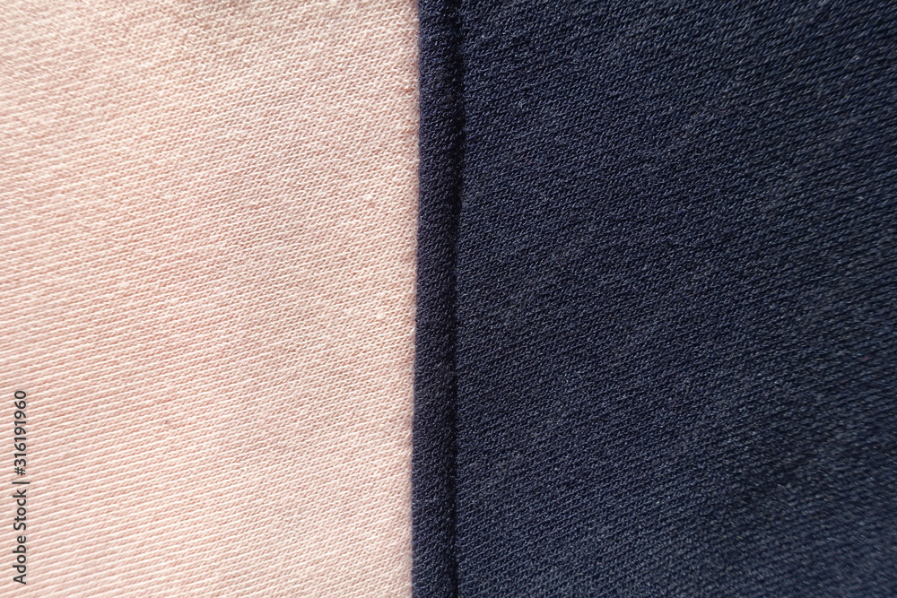 Vertical seam between pink and navy blue jersey fabric