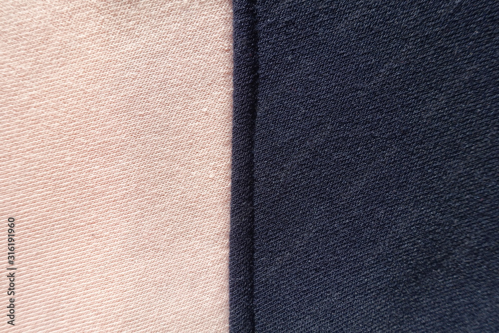 Fototapeta premium Vertical seam between pink and navy blue jersey fabric