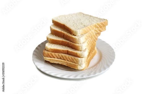 Pile of toasted bread slices on a single white plate. Isolated on white background.