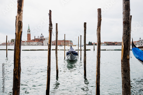 gondola floating on river and San Giorgio Maggiore island in Venice, Italy © LIGHTFIELD STUDIOS