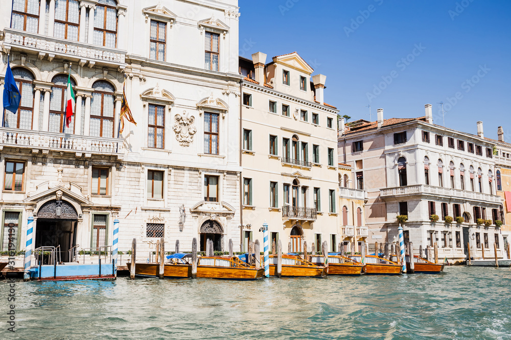 river with motor boats near ancient buildings in Venice, Italy