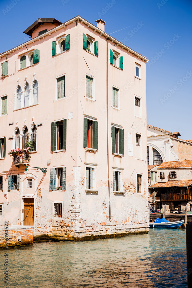 view of ancient building near canal in Venice, Italy