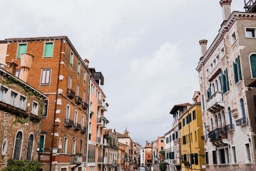 ancient and colorful buildings with plants in Venice, Italy
