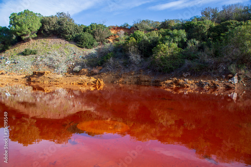 Pollution in the red lake 'Le Conche' on Elba island. Italy
