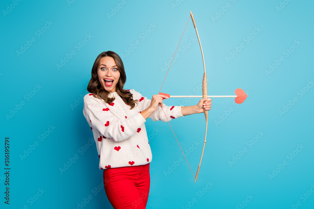 Portrait of her she nice attractive lovely pretty amazed astonished cheerful cheery girl shooting arrow amorous goal isolated on bright vivid shine vibrant blue color background