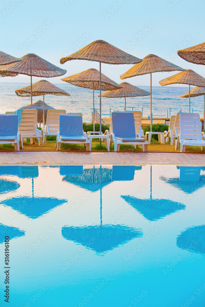 Sea, beach and pool at sunrise. Peace and silence before the arrival of vacationers