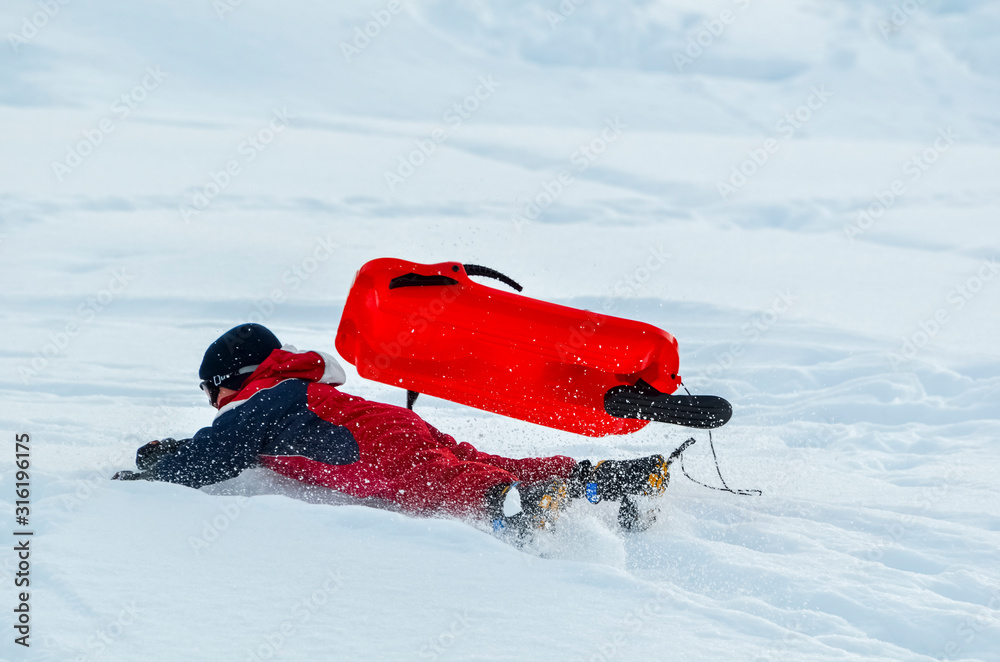 active boy falling from a sled