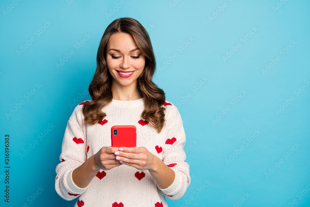 Close-up portrait of her she nice attractive lovely pretty cute cheerful girl using device spending vacation free time chatting sending sms isolated on bright vivid shine vibrant blue color background