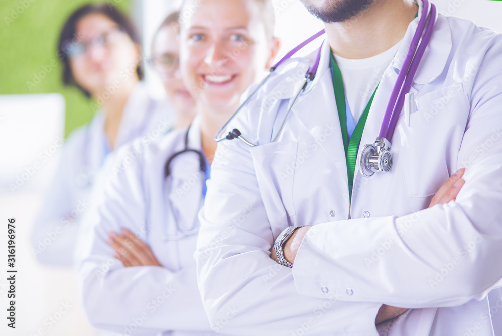 Fototapeta premium Happy medical team comprising male and female doctors smiling broadly and giving a thumbs up of success and hope