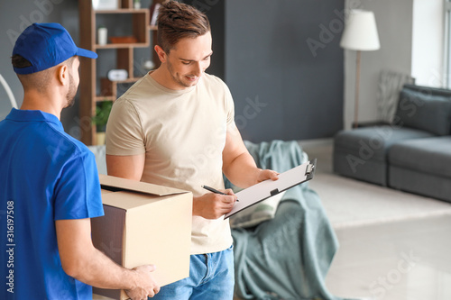 Man signing documents to confirm receiving of order from delivery company