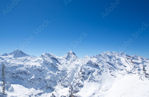 Winter landscape  Mountains covered by snow with clear blue sky without clouds in sunnyday winter in Switzerland