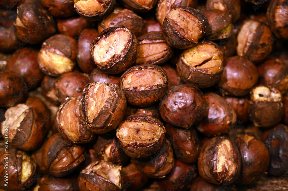 A heap of roasted chestnuts on a market in Osaka-Japan. A heap of roasted chestnuts on a market in Osaka-Japan.