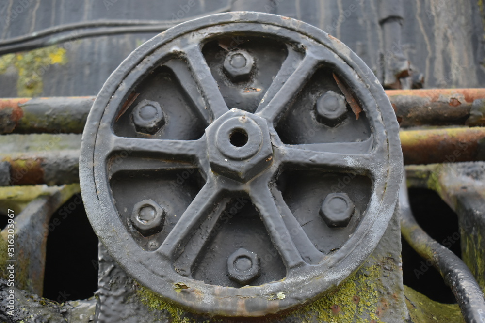 black cover with 6 bolts on a vintage train engine
