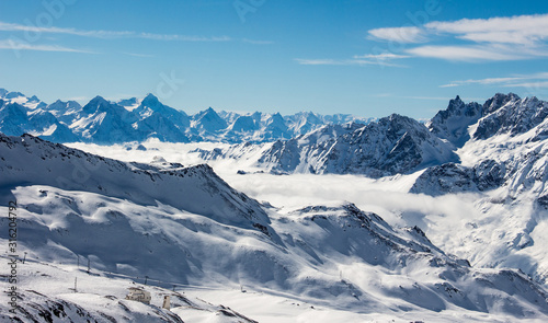Zermatt sea of clouds in valley mountains emerging view perfect sky
