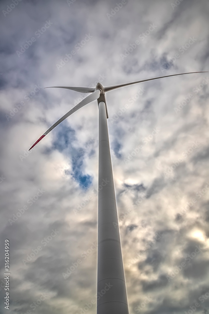 A wind turbine. The windmill for electric power production. Green energy.