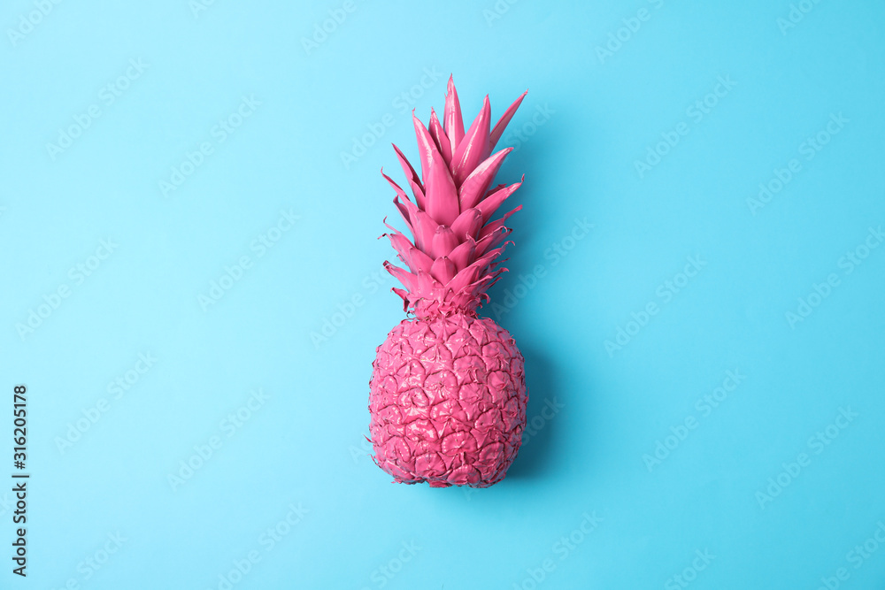 Fototapeta Painted pink pineapple on blue background, space for text