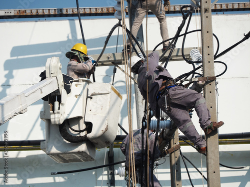 electrician man working at height and dangerous ,high voltage power line maintenance