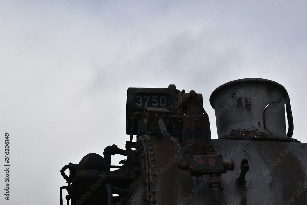 steam engine smoke stack on a cloudy day