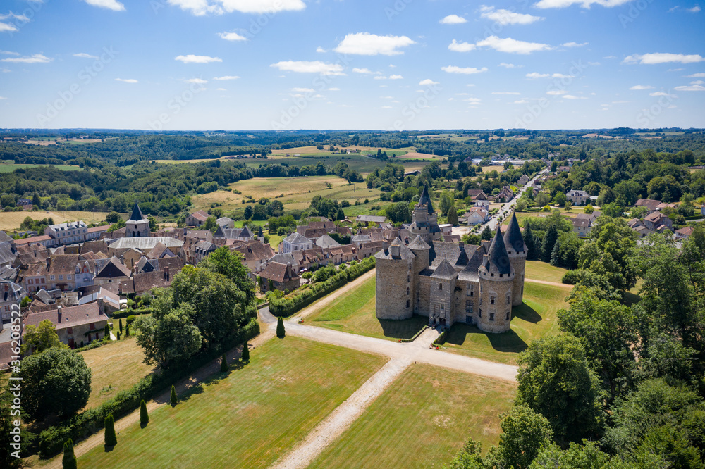 aerial view of a french castle nearby an old village