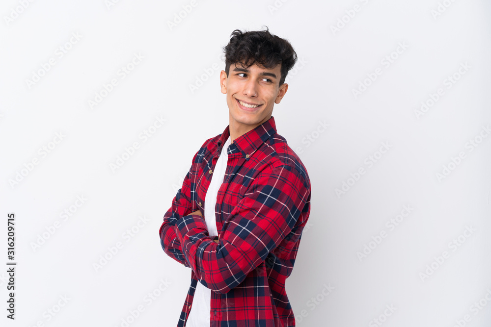 Young Argentinian man over isolated white background with arms crossed and happy Young Argentinian man over isolated white background with arms crossed and happy