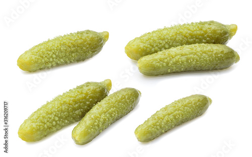 three marinated pickled cucumbers isolated on white