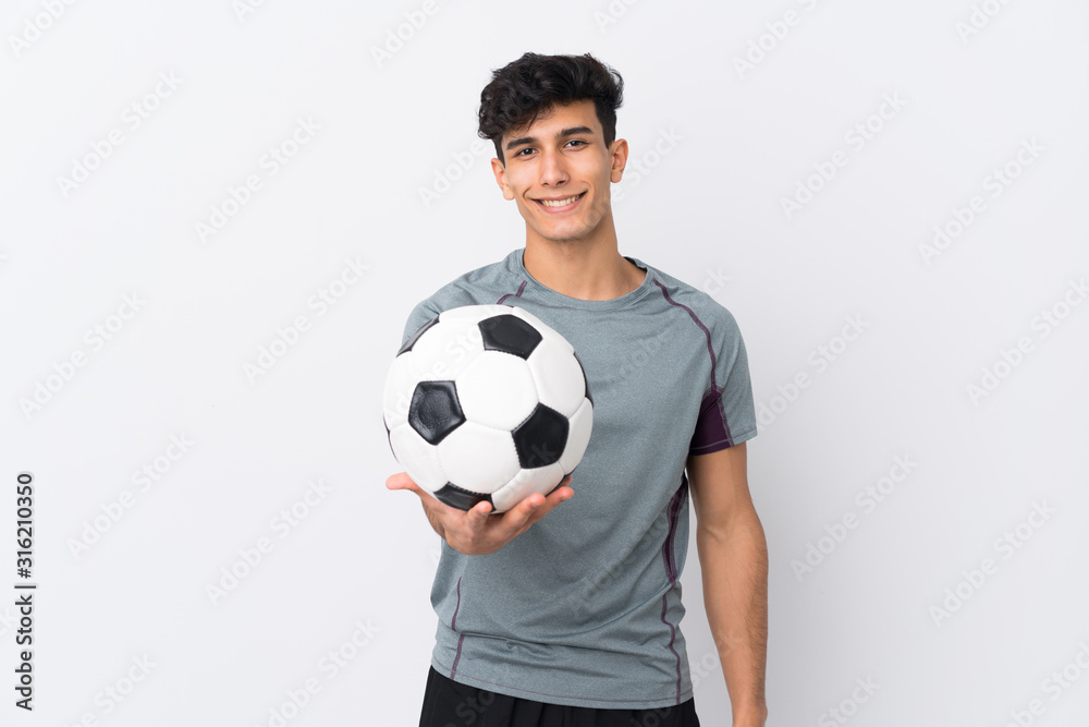 Young Argentinian man over isolated white background with soccer ball