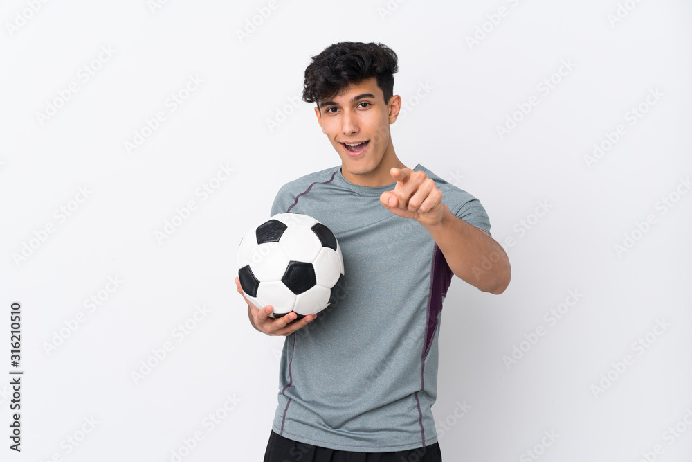 Argentinian football player man over isolated white background surprised and pointing front