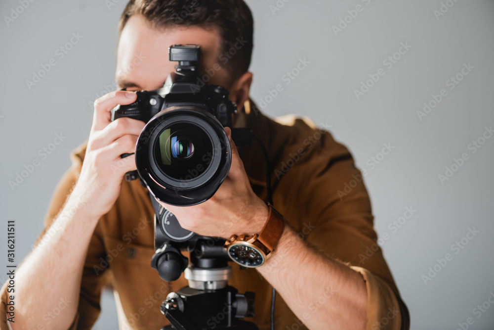 selective focus of photographer taking photo with digital camera on backstage selective focus of photographer taking photo with digital camera on backstage