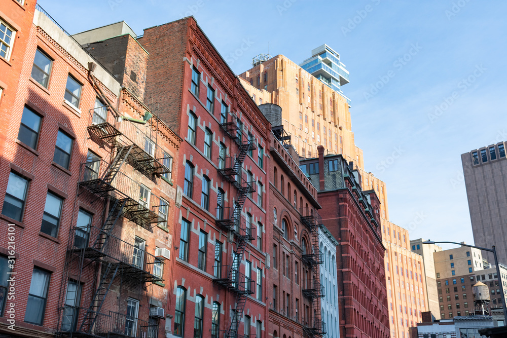 Fototapeta premium Colorful Old Buildings with Fire Escapes in Tribeca New York