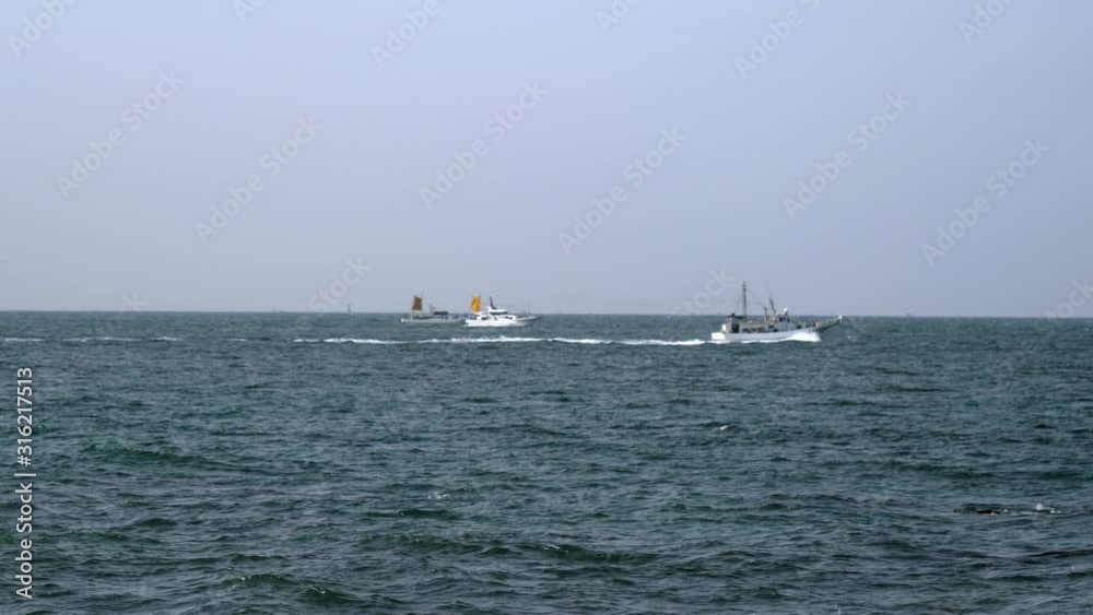 Three boats sailing in the beach of Koijigahama Three boats sailing in the beach of Koijigahama