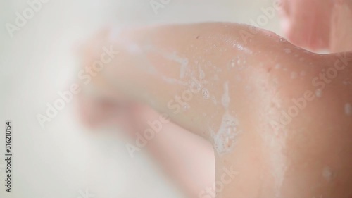 woman taking a shower in slow motion, washing and enjoy herself under a shower