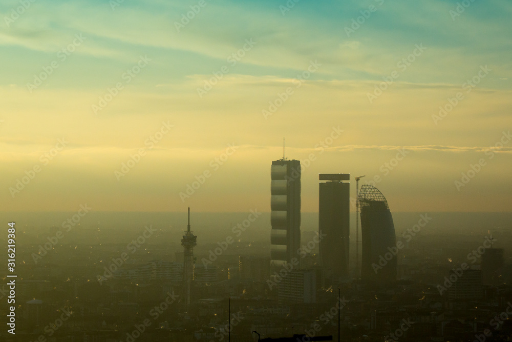 Fototapeta premium Milan landscape with smog, aerial view of the city with polluted air.
