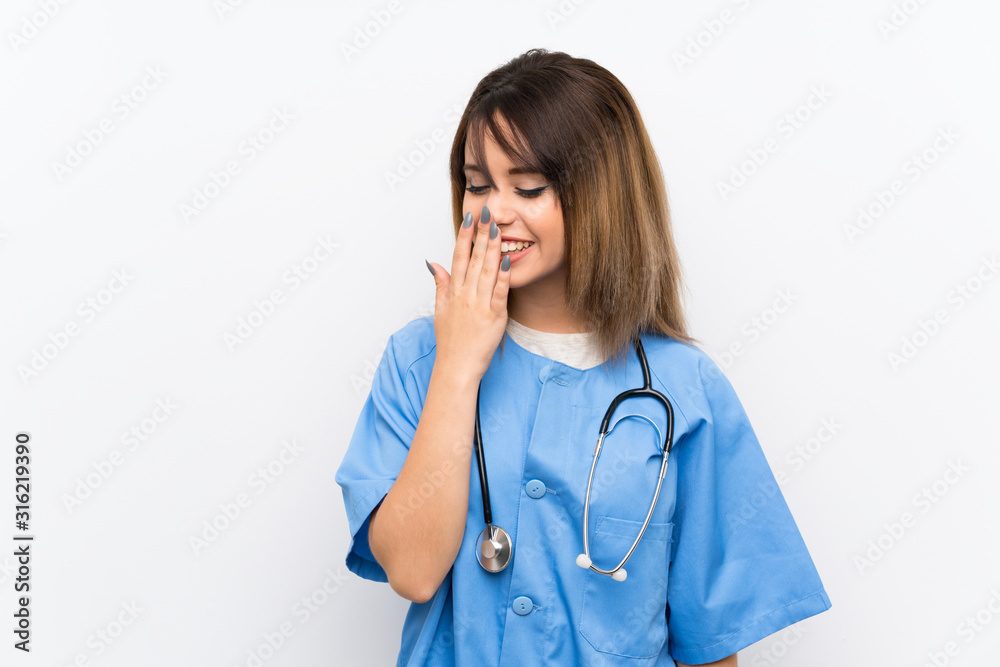 Young nurse woman over white wall smiling a lot Young nurse woman over white wall smiling a lot