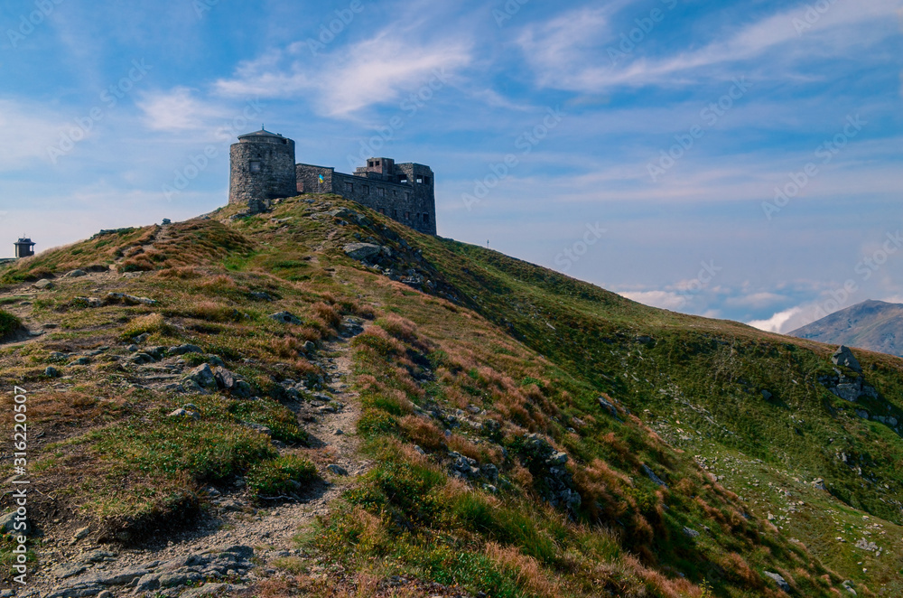 The old stone observatory stands on peak of the Carpathian Mountains