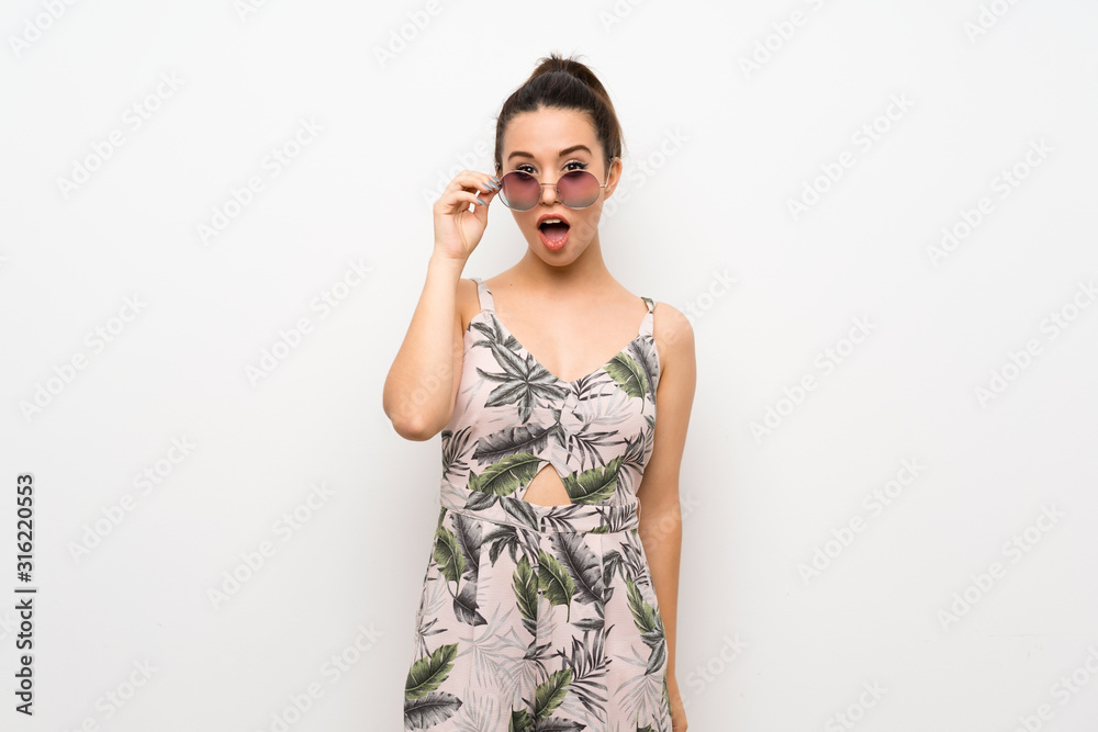 Young woman over isolated white background with glasses and surprised Young woman over isolated white background with glasses and surprised