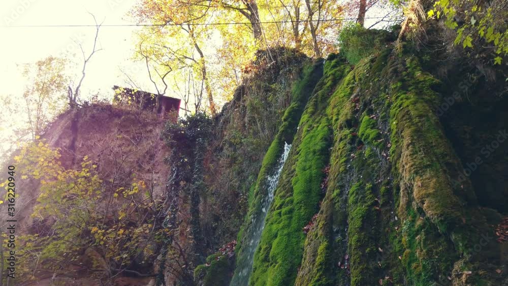 Down to Up panning shot of beautiful Vadu Crisului Waterfall located in Bihor Romania taken during a Sunny Autumn Day Down to Up panning shot of beautiful Vadu Crisului Waterfall located in Bihor Romania taken during a Sunny Autumn Day