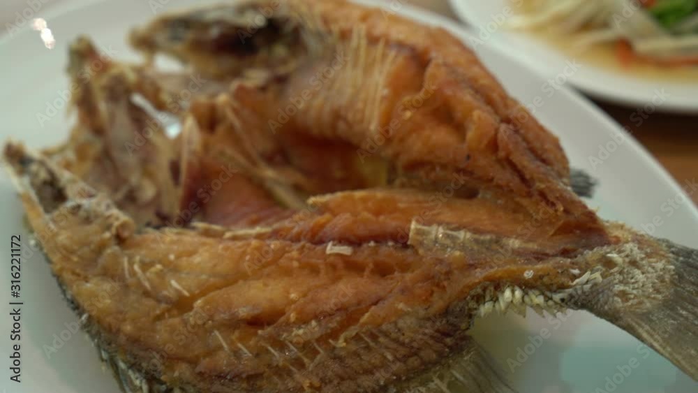 Fried snapper fish topped with fish sauce Fried snapper fish topped with fish sauce