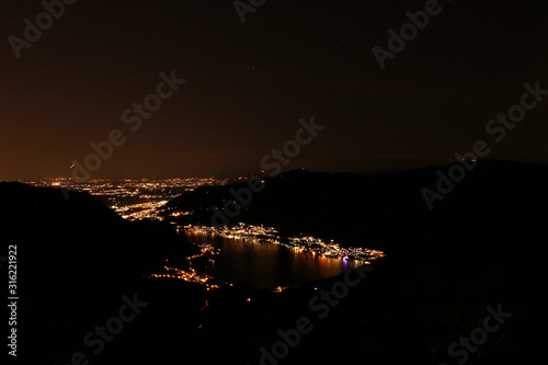 Panorama notturno con vista sul lago di Como dal monte palanzone in Lombardia photo