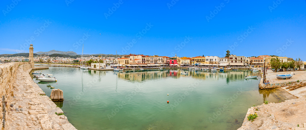 Fototapeta premium Panoramic picture of Rethymno harbor with promenade and lighthouse in summer