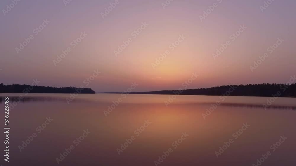Aerial low flight avove calm lake during sunset, Suwalszczyzna, Poland, towards shot Aerial low flight avove calm lake during sunset, Suwalszczyzna, Poland, towards shot