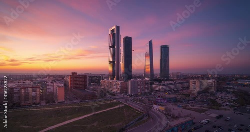 Day to night panoramic time lapse Madrid city skyscrapers. Beautiful sunset Four Towers business area. photo