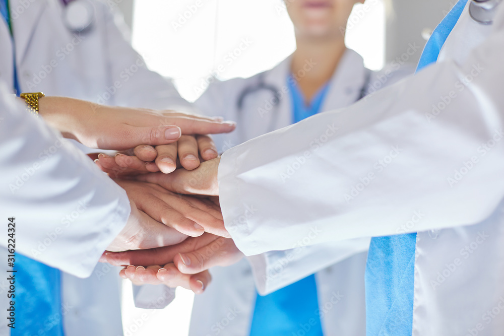 Doctors and nurses in a medical team stacking hands Doctors and nurses in a medical team stacking hands